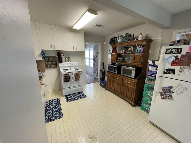 kitchen with white cabinets and white appliances