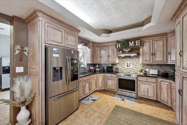 7645 Old Big Hill Rd, Beaumont, TX 77705 - kitchen with appliances with stainless steel finishes, a sink, dark countertops, decorative backsplash, and a tray ceiling