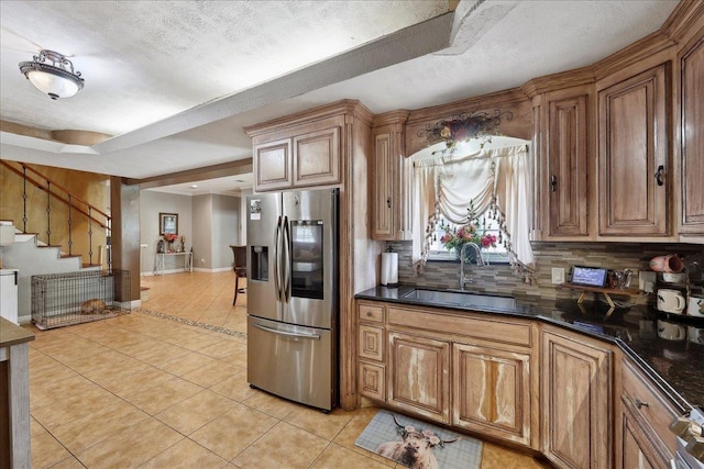 7645 Old Big Hill Rd, Beaumont, TX 77705 - kitchen featuring stainless steel fridge with ice dispenser, a sink, light tile patterned floors, dark countertops, and a textured ceiling