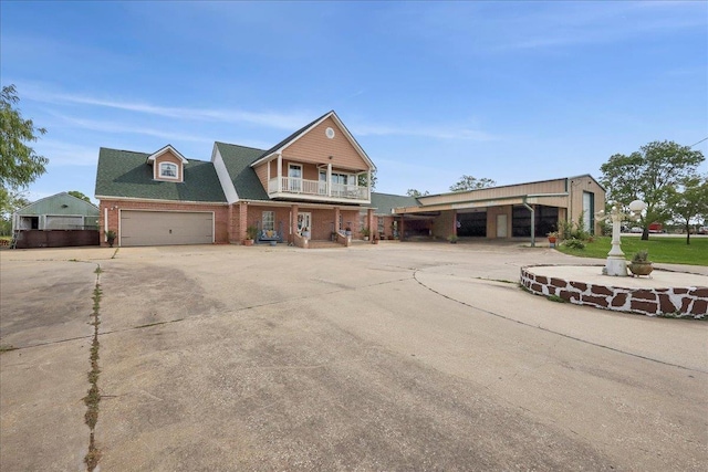 7645 Old Big Hill Rd, Beaumont, TX 77705 - view of front of property with brick siding, a balcony, and concrete driveway