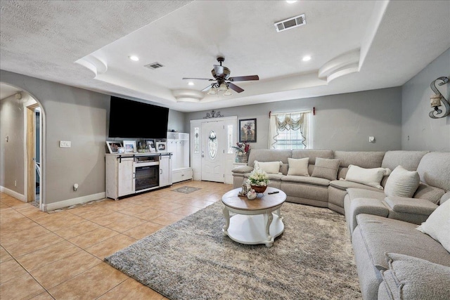 7645 Old Big Hill Rd, Beaumont, TX 77705 - living area with a raised ceiling, light tile patterned floors, arched walkways, ceiling fan, and recessed lighting