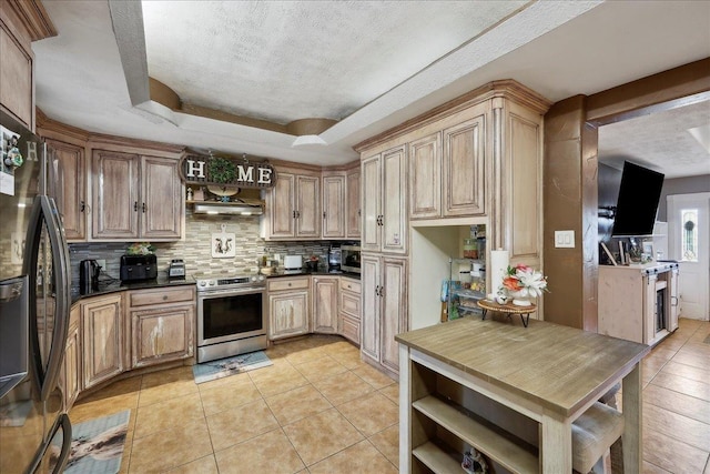 7645 Old Big Hill Rd, Beaumont, TX 77705 - kitchen featuring appliances with stainless steel finishes, a raised ceiling, tasteful backsplash, a textured ceiling, and light tile patterned floors