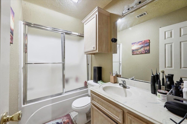 7645 Old Big Hill Rd, Beaumont, TX 77705 - bathroom featuring vanity, combined bath / shower with glass door, toilet, and a textured wall