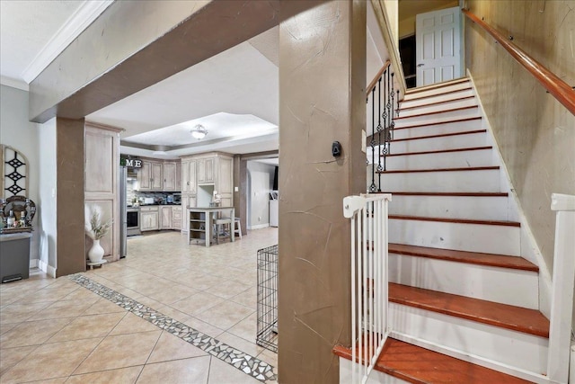 7645 Old Big Hill Rd, Beaumont, TX 77705 - stairway with tile patterned flooring, a tray ceiling, and ornamental molding