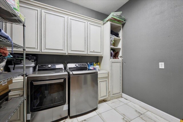 7645 Old Big Hill Rd, Beaumont, TX 77705 - laundry room featuring cabinet space, washing machine and dryer, light marble finish floors, and baseboards