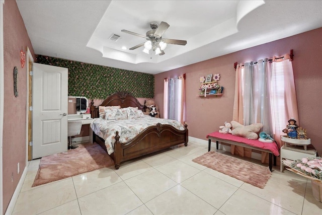 7645 Old Big Hill Rd, Beaumont, TX 77705 - bedroom featuring a raised ceiling, baseboards, an accent wall, a ceiling fan, and light tile patterned flooring
