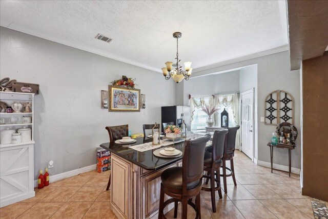 7645 Old Big Hill Rd, Beaumont, TX 77705 - dining space featuring a chandelier, light tile patterned floors, ornamental molding, baseboards, and a textured ceiling