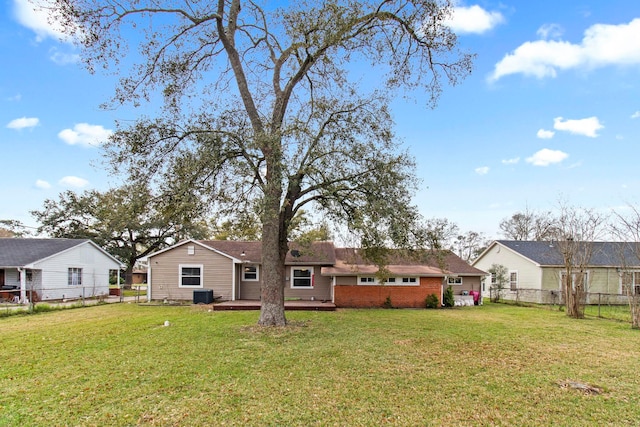 rear view of property featuring central air condition unit, a yard, fence, and a wooden deck