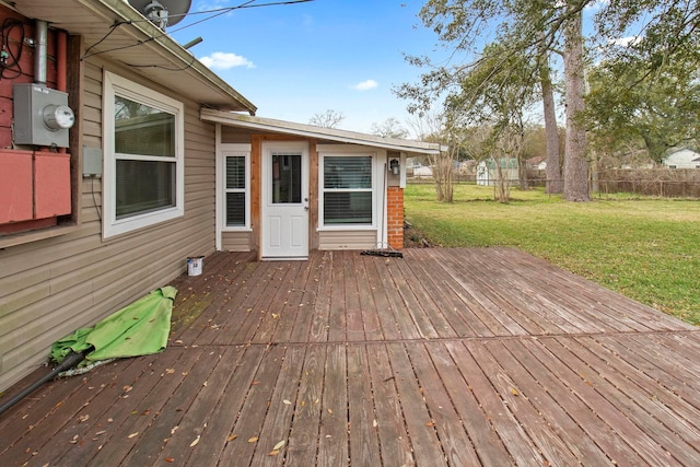 wooden terrace with a yard and fence