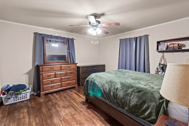 bedroom with crown molding, wood finished floors, and ceiling fan