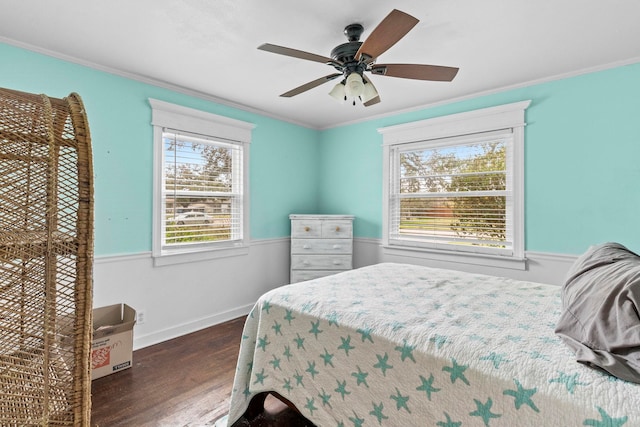 bedroom with dark wood-type flooring, a ceiling fan, baseboards, and ornamental molding