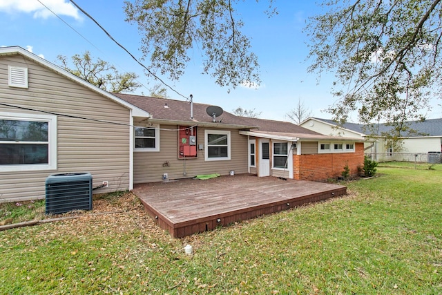 back of house with a lawn, a deck, central AC, fence, and brick siding