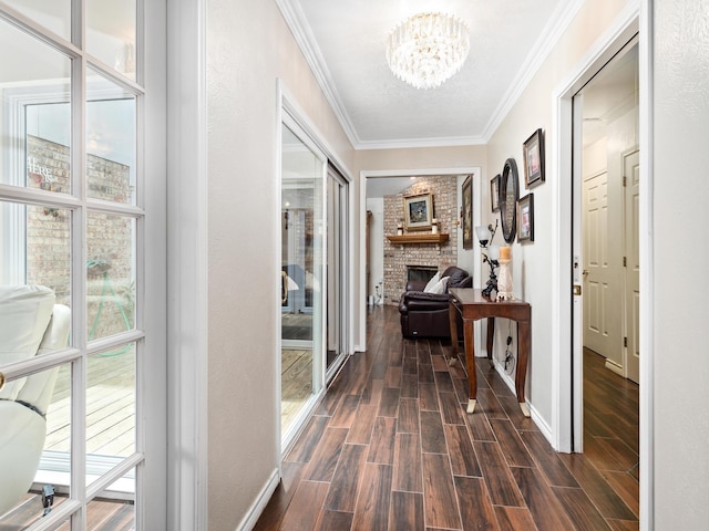 hallway with crown molding and a chandelier