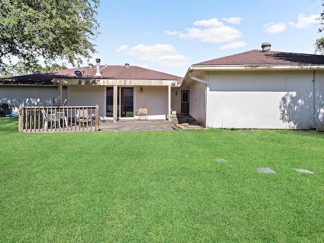 back of house with a patio and a lawn