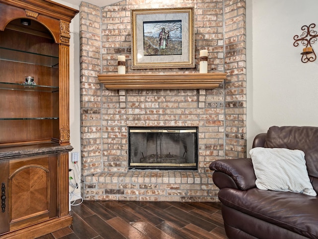 living room with a brick fireplace