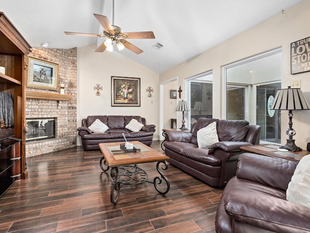 living room featuring a brick fireplace, ceiling fan, and lofted ceiling