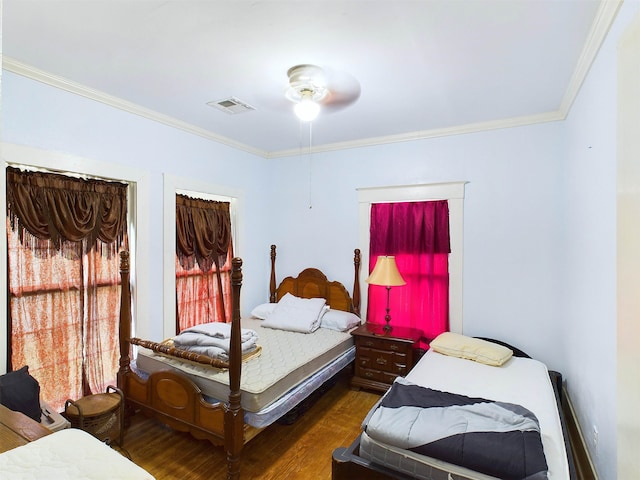 bedroom featuring ceiling fan, crown molding, and dark wood-type flooring