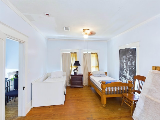 bedroom featuring light hardwood / wood-style floors and ornamental molding