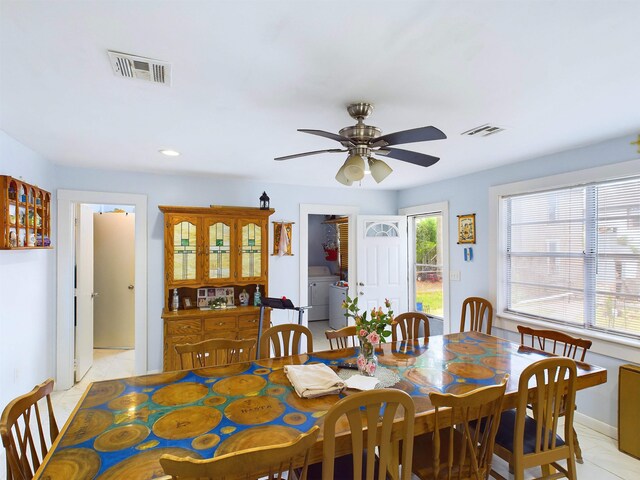 dining area featuring ceiling fan and independent washer and dryer