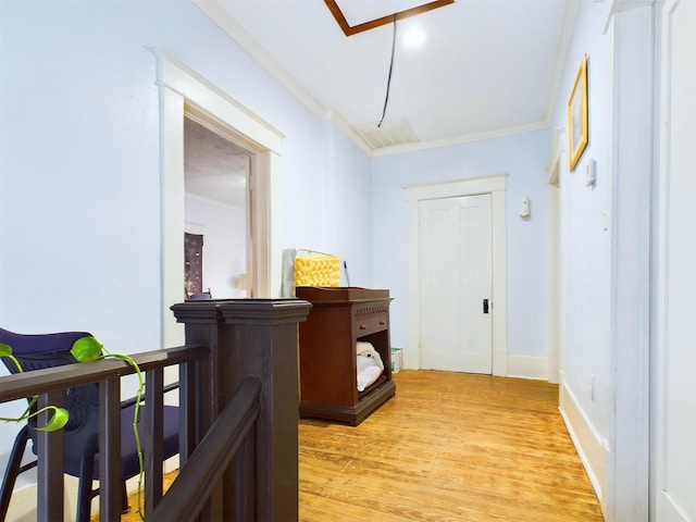 corridor with crown molding and light hardwood / wood-style flooring