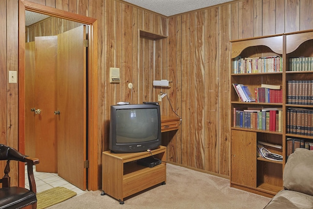 4425 Cartwright St, Beaumont, TX 77707 - sitting room with wooden walls, carpet flooring, and a textured ceiling