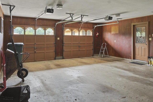 4425 Cartwright St, Beaumont, TX 77707 - garage featuring wood walls and a garage door opener