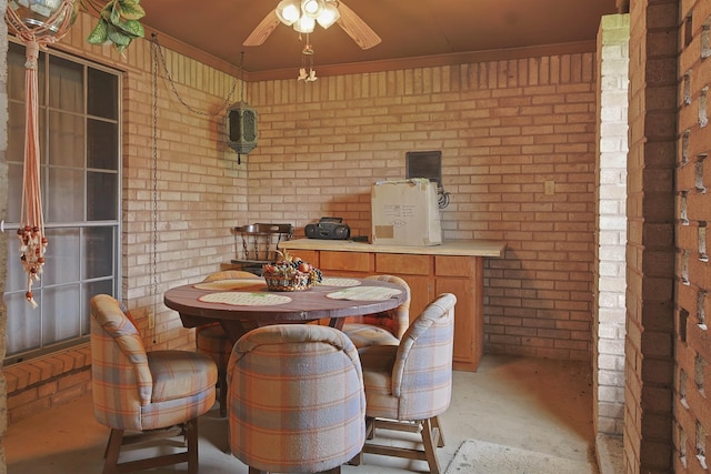4425 Cartwright St, Beaumont, TX 77707 - dining area featuring brick wall, concrete flooring, a ceiling fan, and ornamental molding