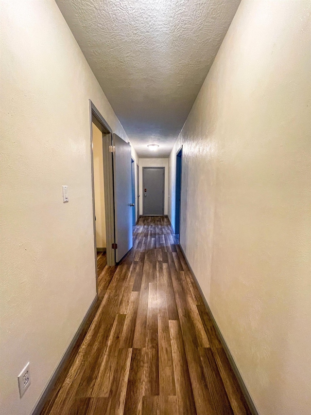 8140 Tx State Highway 62, Buna, TX 77612 - hall with dark wood-style floors and a textured ceiling