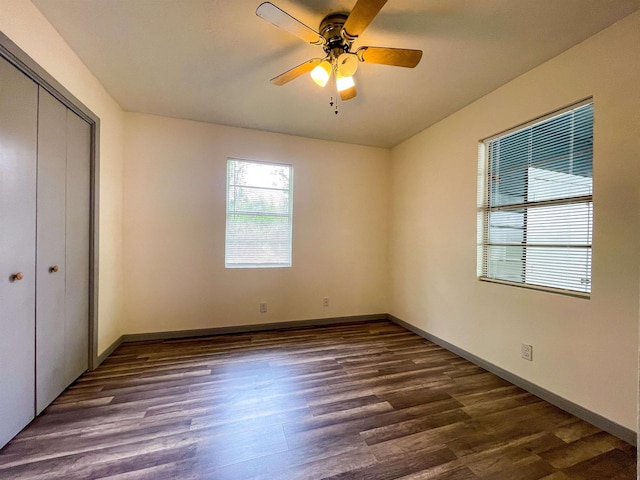 8140 Tx State Highway 62, Buna, TX 77612 - unfurnished bedroom with a closet, ceiling fan, baseboards, and dark wood-style floors