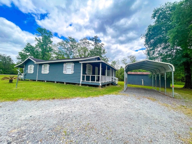 8140 Tx State Highway 62, Buna, TX 77612 - manufactured / mobile home featuring a front yard, a detached carport, and gravel driveway