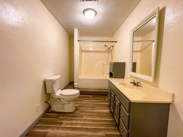 8140 Tx State Highway 62, Buna, TX 77612 - bathroom featuring vanity, a textured ceiling, toilet, visible vents, and wood finished floors