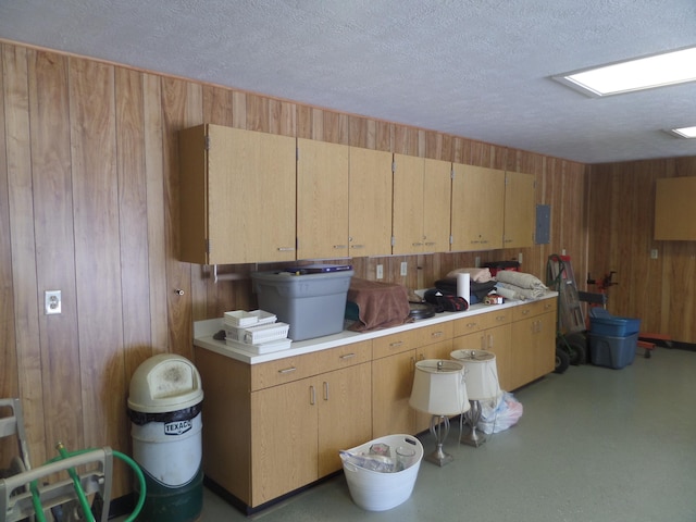 7035 Carroll Ln, Beaumont, TX 77713 - kitchen featuring wooden walls, light countertops, and a textured ceiling