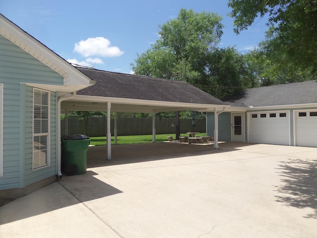 7035 Carroll Ln, Beaumont, TX 77713 - exterior space with concrete driveway, fence, an attached garage, and a carport