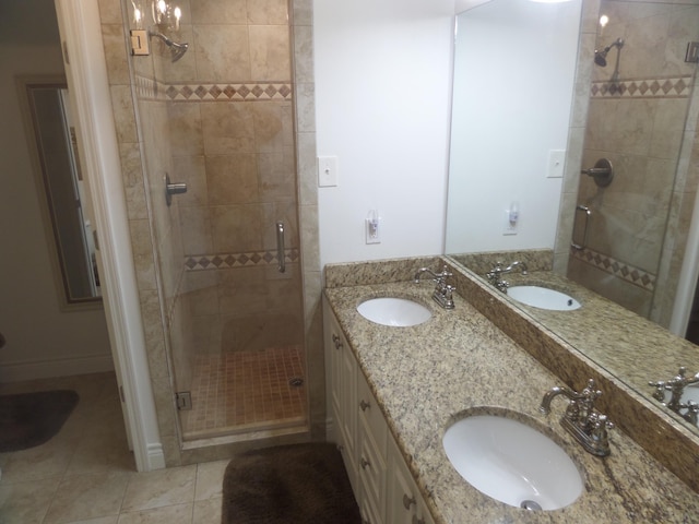 7035 Carroll Ln, Beaumont, TX 77713 - bathroom featuring a stall shower, tile patterned floors, and double vanity