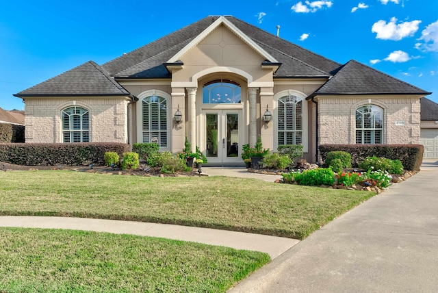 french provincial home with french doors and a front yard