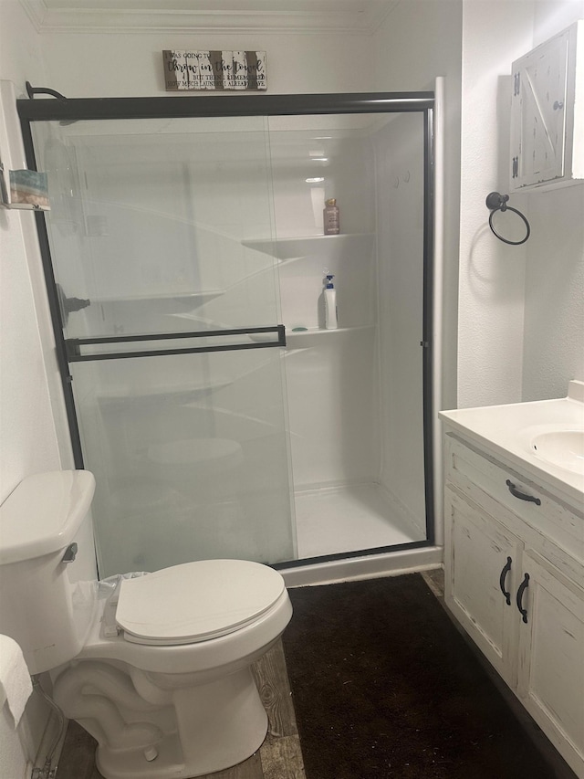 full bathroom with toilet, ornamental molding, a shower stall, and vanity