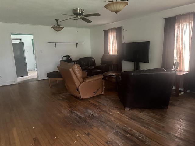 living room featuring ceiling fan and dark wood-style flooring