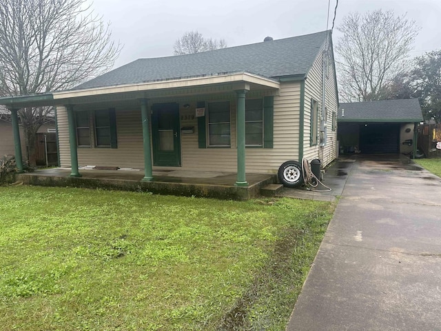 bungalow with a shingled roof, a front lawn, a porch, and concrete driveway