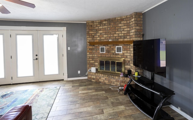 4715 Regina Ln, Beaumont, TX 77706 - living area featuring a ceiling fan, ornamental molding, wood finished floors, a fireplace, and french doors