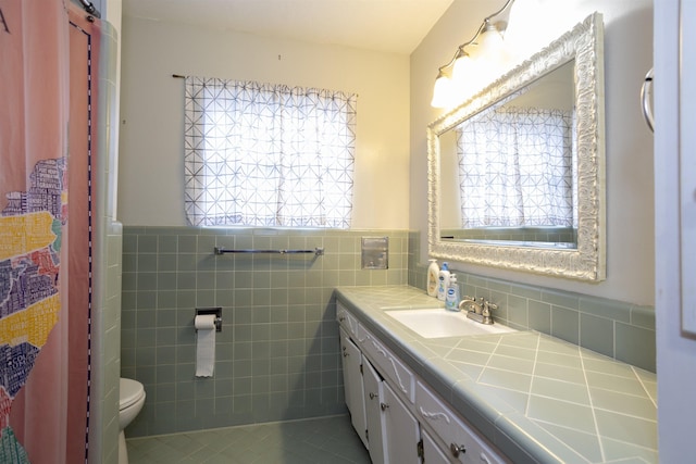 4715 Regina Ln, Beaumont, TX 77706 - bathroom featuring vanity, tile walls, wainscoting, and tile patterned floors