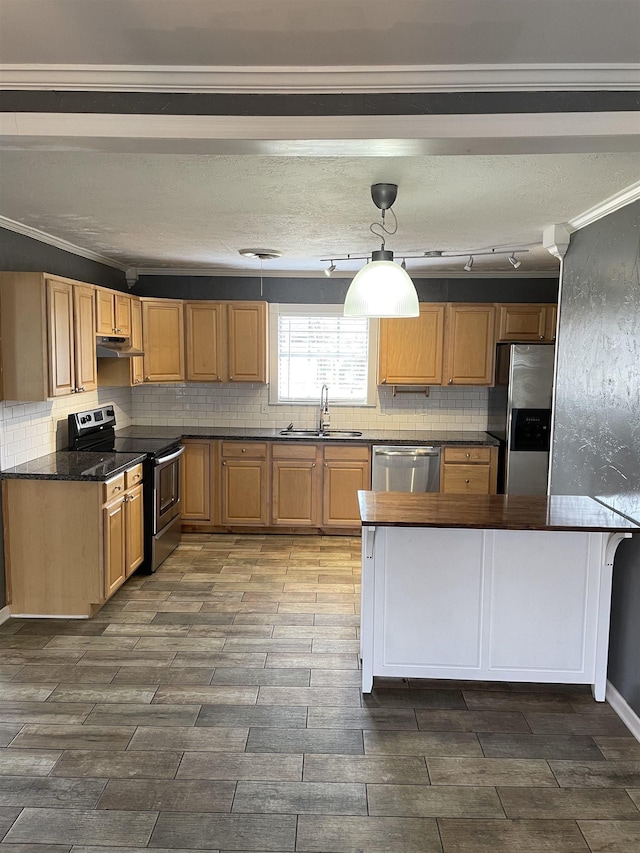 4715 Regina Ln, Beaumont, TX 77706 - kitchen with stainless steel appliances, backsplash, wood finish floors, ornamental molding, and extractor fan