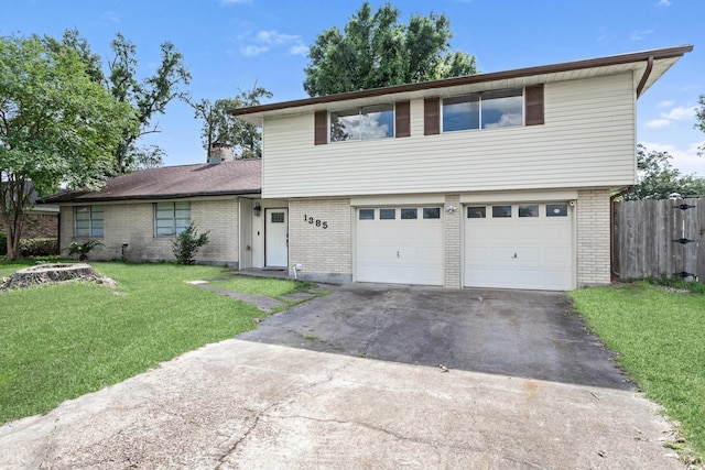 1385 Howell St, Beaumont, TX 77706 - view of front of property with asphalt driveway, brick siding, and an attached garage