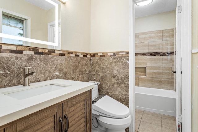 1385 Howell St, Beaumont, TX 77706 - full bathroom with vanity, tile patterned floors, tile walls, and shower / bathtub combination