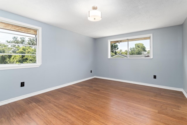 1385 Howell St, Beaumont, TX 77706 - spare room with baseboards and wood finished floors