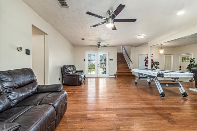 1385 Howell St, Beaumont, TX 77706 - playroom with french doors, a ceiling fan, light wood-style flooring, and a textured ceiling