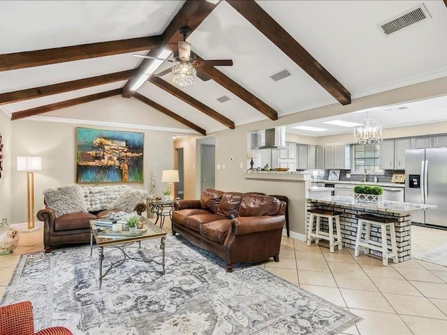 tiled living room with vaulted ceiling with beams and ceiling fan with notable chandelier