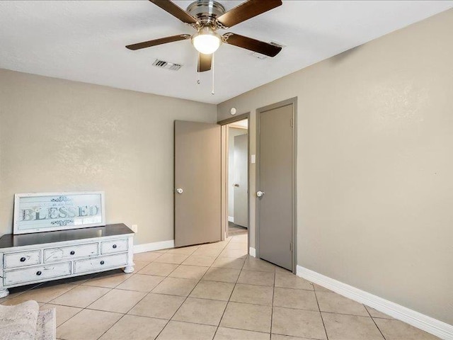 unfurnished bedroom featuring light tile patterned floors and ceiling fan