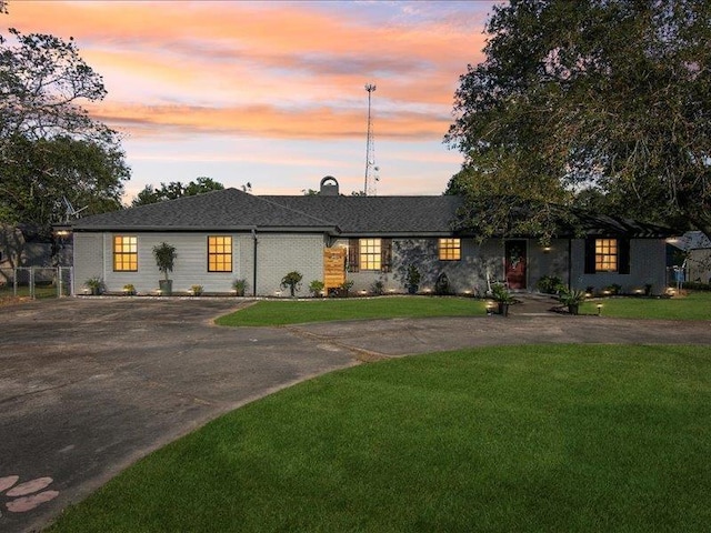 ranch-style home with a yard