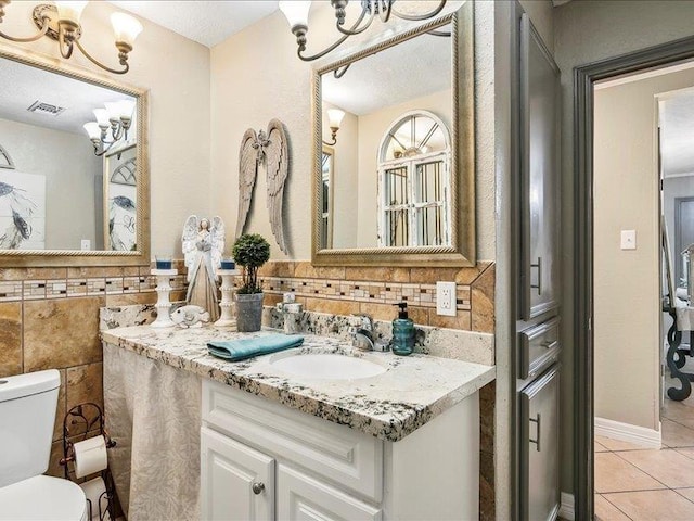 bathroom featuring tile patterned flooring, vanity, and toilet