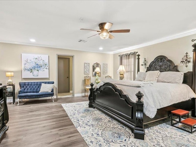 bedroom featuring light hardwood / wood-style floors, ceiling fan, and ornamental molding